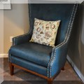 F12. Pair of leatherette wing chairs with nailhead trim. 44"h x 35"w x 34"d 